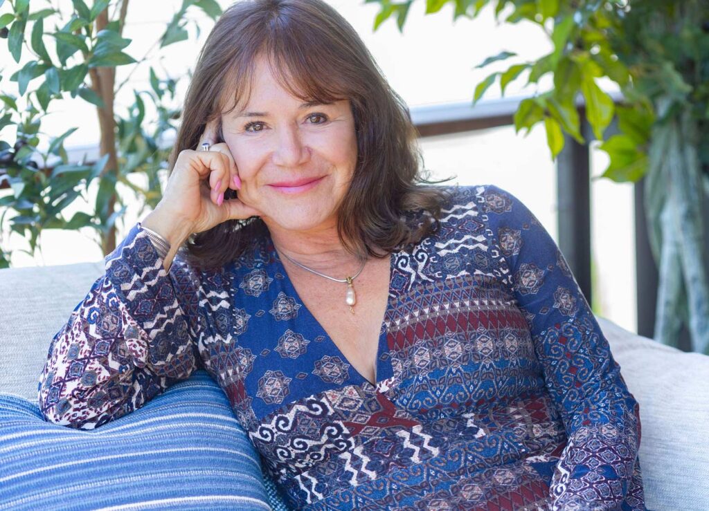 Edie Otis relaxing on couch waiting for your email.